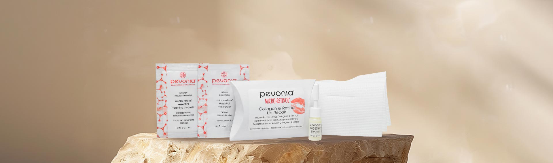 Pevonia's Collagen Hand Cream underneath some leaves, with shadows cascading down onto a beige backdrop.