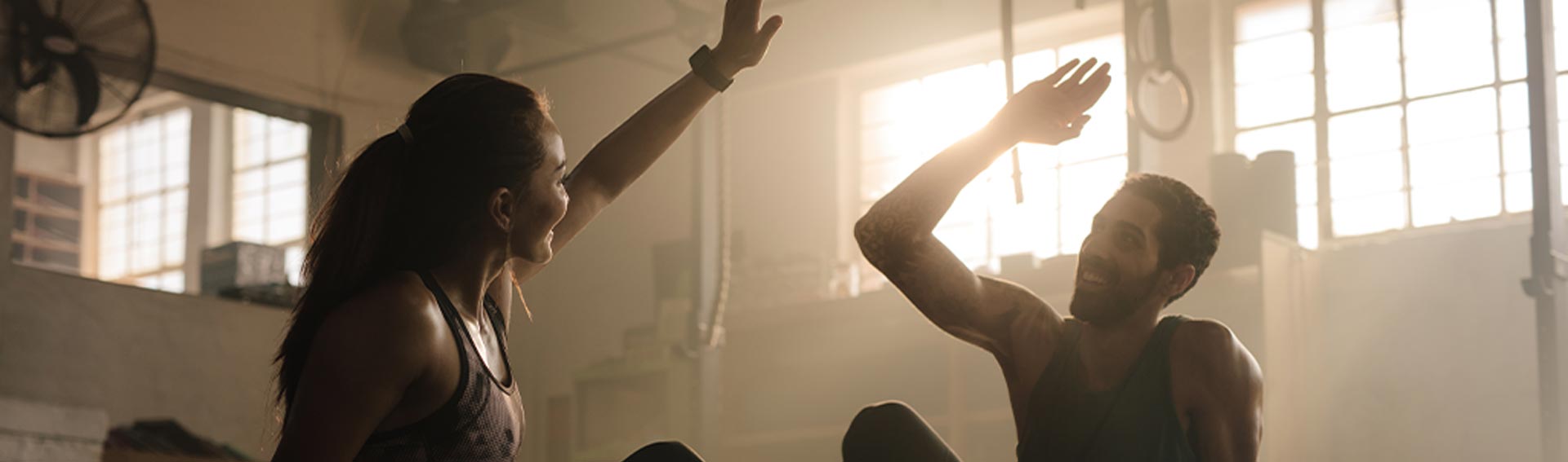 Man and woman high fiving after a workout.