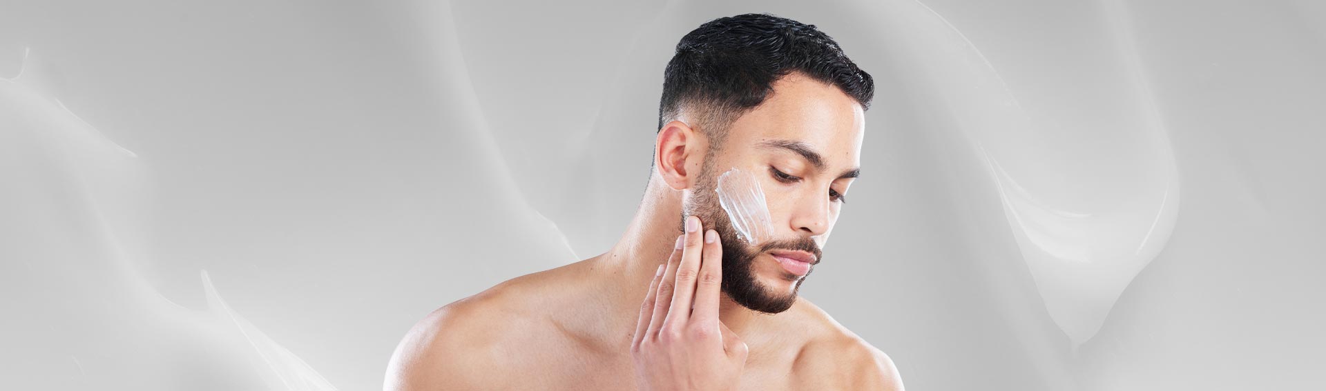 A man applying a Pevonia moisturizer to his face.