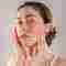 Young woman with rosacea on her cheek.